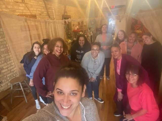 Group of women smiling together indoors at Anne's Haven